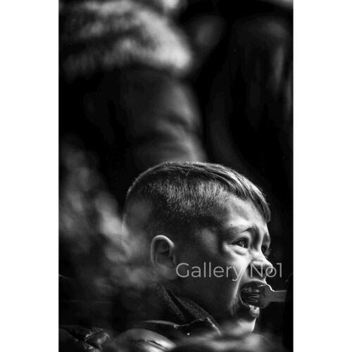 FIND STREET PHOTOGRAPHY IMAGE OF A YOUNG BOY EATING BY MATTHEW WARDELL